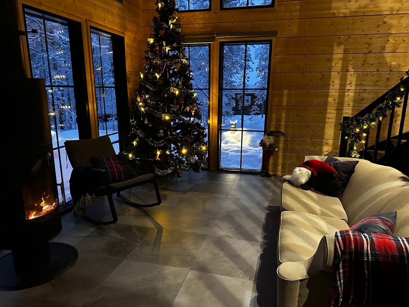 Living room with floor-to-ceiling glazing and a wood-burning stove